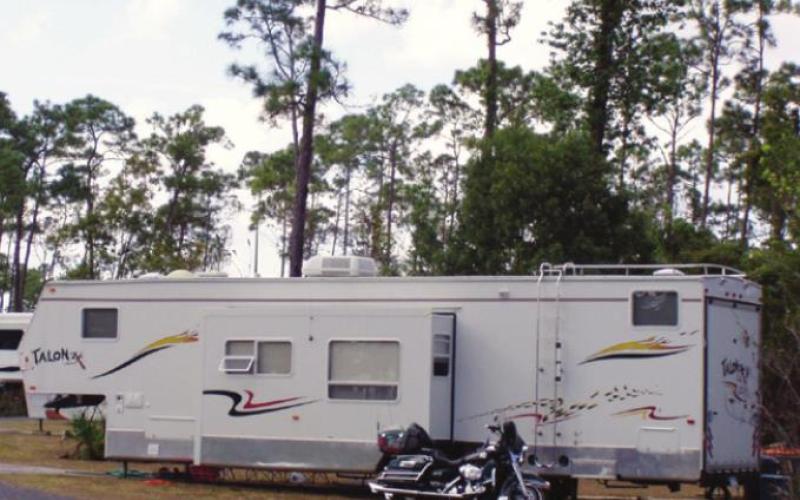 This fifth-wheel trailer has slide-outs for more living space and a “toy hauler” room in the back for essentials such as the Harley. How much space do you need?