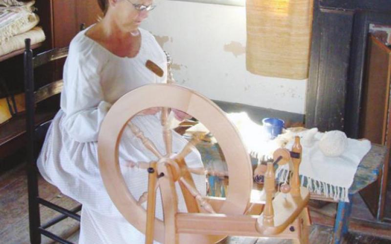 At Vermilionville, docents demonstrate traditional household skills such as spinning and weaving.