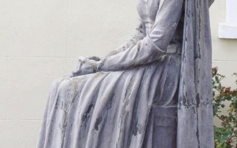 A statue of Evangeline stands behind St, Martin de Tours, the 1765 home church of the Cajuns.