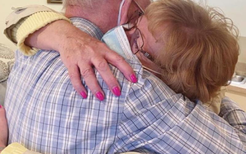 Elizabeth Scott Community resident Jess Petree hugs his daughter, Sherri Fischer, during Sherri’s recent visit to the facility.