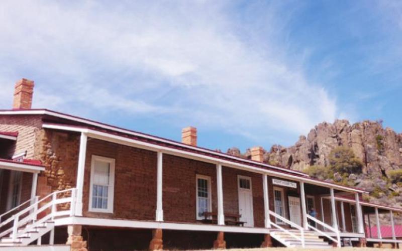 The post hospital was the largest building, set far back from others at the base of the cliff.