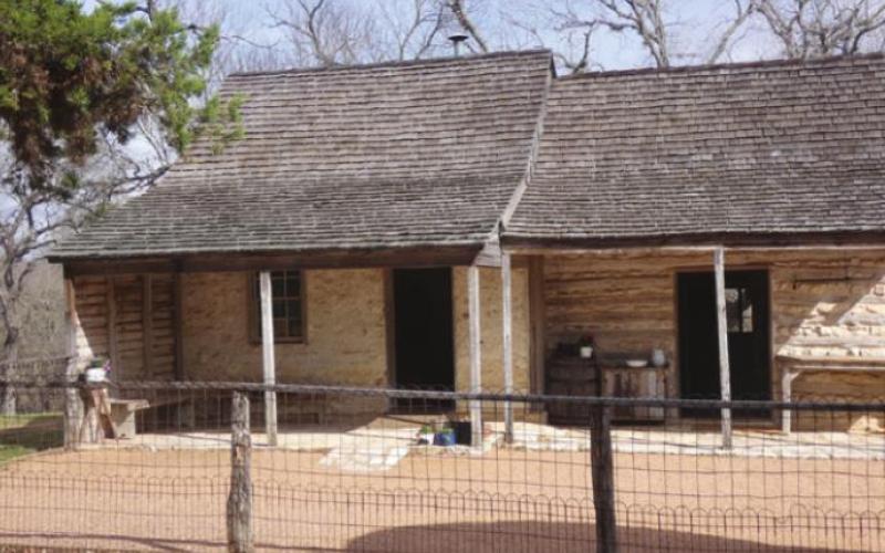 The original log structures of the farm are still there as part of the work space.