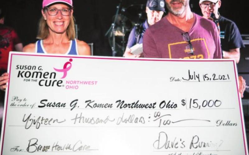 Cheryl Walter, Susan G. Komen Northwest Ohio (left); James Mason, owner, Dave’s Running Shop (right). Dave’s presented a check to Susan G. Komen Northwest Ohio at the annual customer appreciation celebration at Centennial Terrace on July 15, 2021.