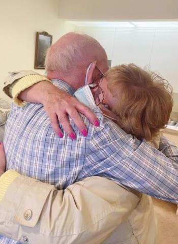 Elizabeth Scott Community resident Jess Petree hugs his daughter, Sherri Fischer, during Sherri’s recent visit to the facility.