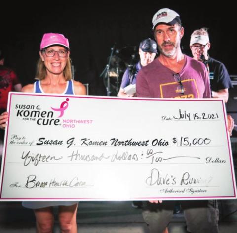 Cheryl Walter, Susan G. Komen Northwest Ohio (left); James Mason, owner, Dave’s Running Shop (right). Dave’s presented a check to Susan G. Komen Northwest Ohio at the annual customer appreciation celebration at Centennial Terrace on July 15, 2021.