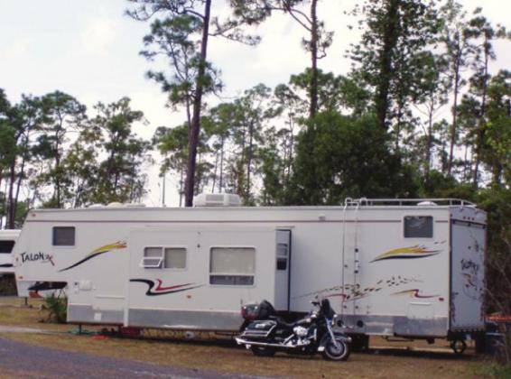 This fifth-wheel trailer has slide-outs for more living space and a “toy hauler” room in the back for essentials such as the Harley. How much space do you need?