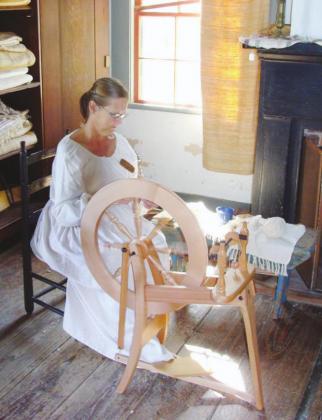 At Vermilionville, docents demonstrate traditional household skills such as spinning and weaving.