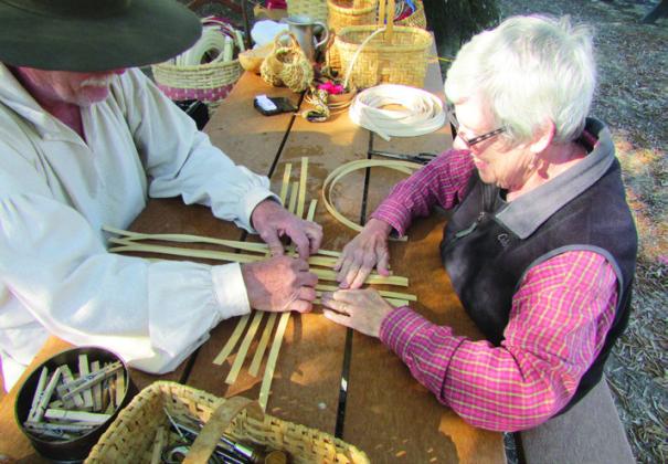During Pioneer Days on the Trace, J.D. taught Shirley how to weave a basket.